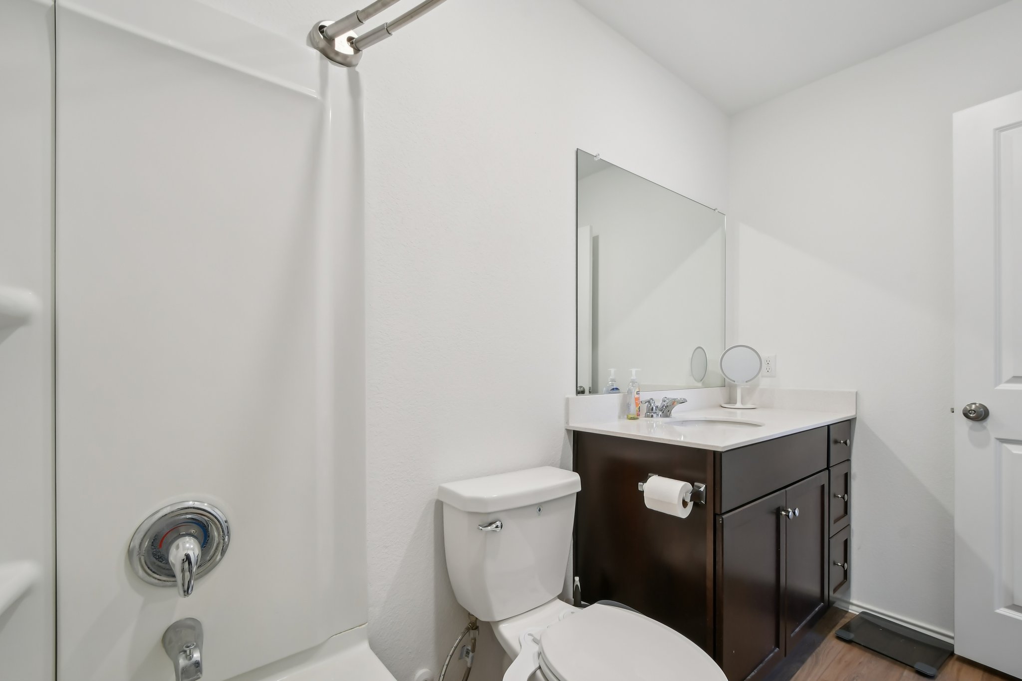 14116 Mussel Run Elgin, TX 78621 - Photo 19 of 25 Full bath featuring vanity, shower / bathtub combination with curtain, and light wood-type flooring