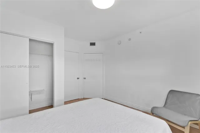 a bedroom with a bed and a chair