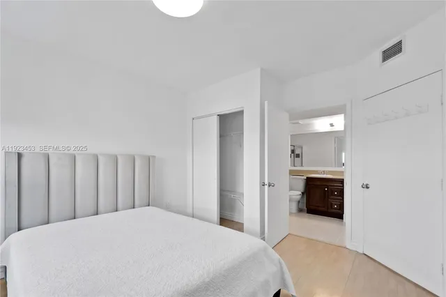 a bedroom with a large bed and dresser