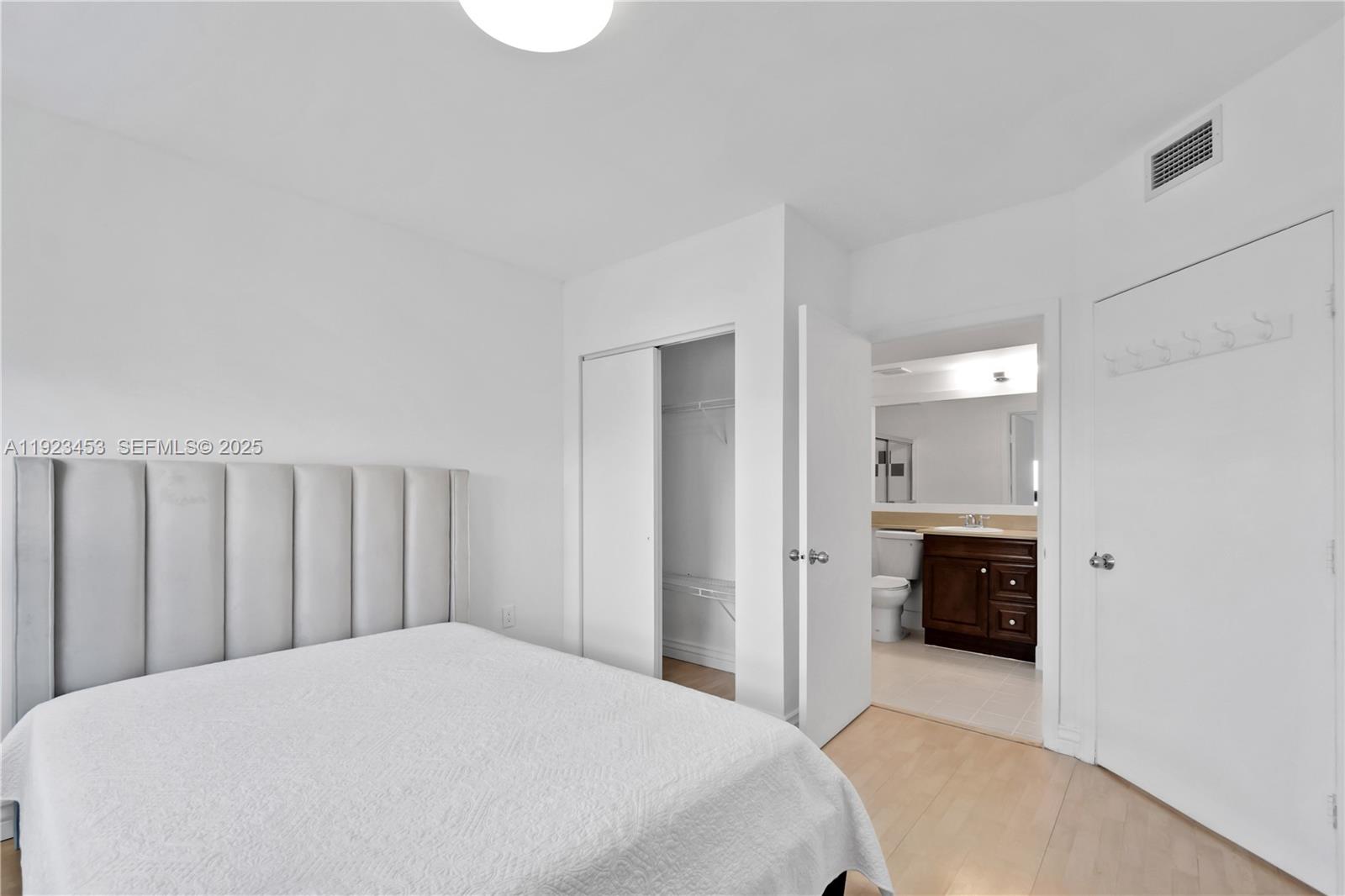 1330 West Avenue, Unit 1009 Miami Beach, FL 33139 - Photo 17 of 43 a bedroom with a large bed and dresser