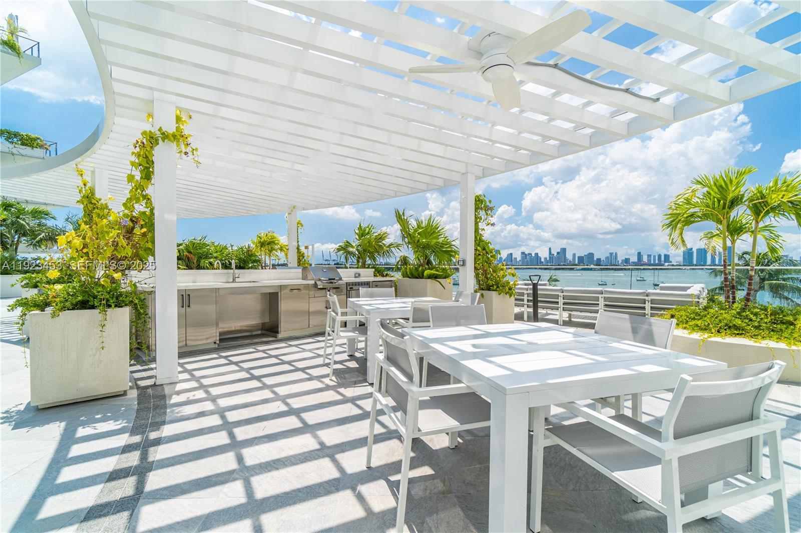 1330 West Avenue, Unit 1009 Miami Beach, FL 33139 - Photo 31 of 43 a outdoor dining space with furniture and a potted plant