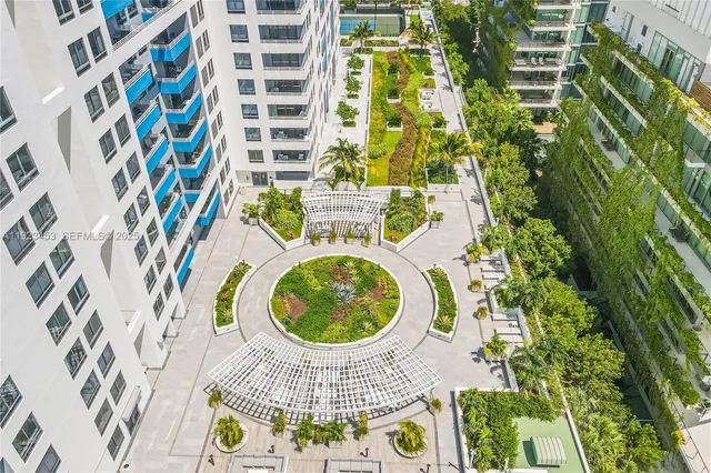 an aerial view of a swimming pool with a garden