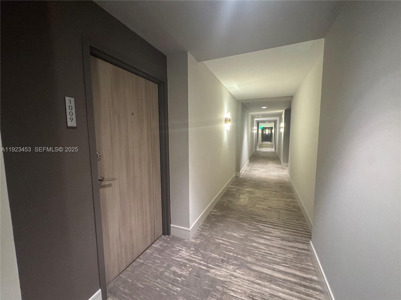 1330 West Avenue, Unit 1009 Miami Beach, FL 33139 - Photo 4 of 43 a view of a hallway with wooden floor