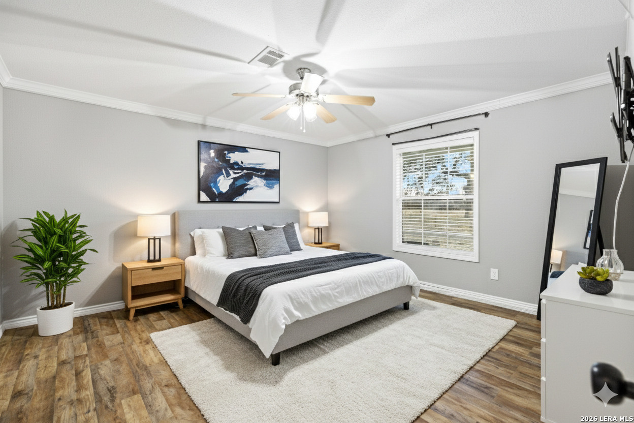 2383 Tomblin Road Bigfoot, TX 78005 - Photo 22 of 61 a spacious bedroom with a large bed and a window