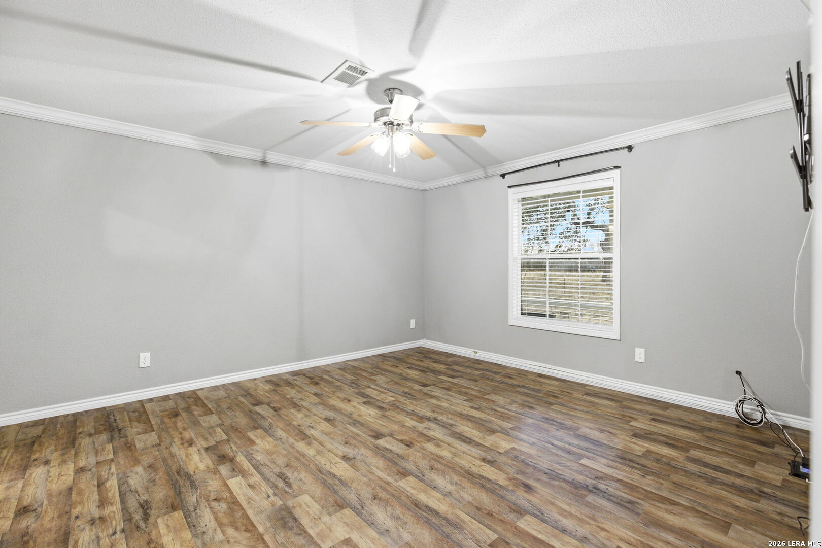 2383 Tomblin Road Bigfoot, TX 78005 - Photo 23 of 61 wooden floor in an empty room with a window