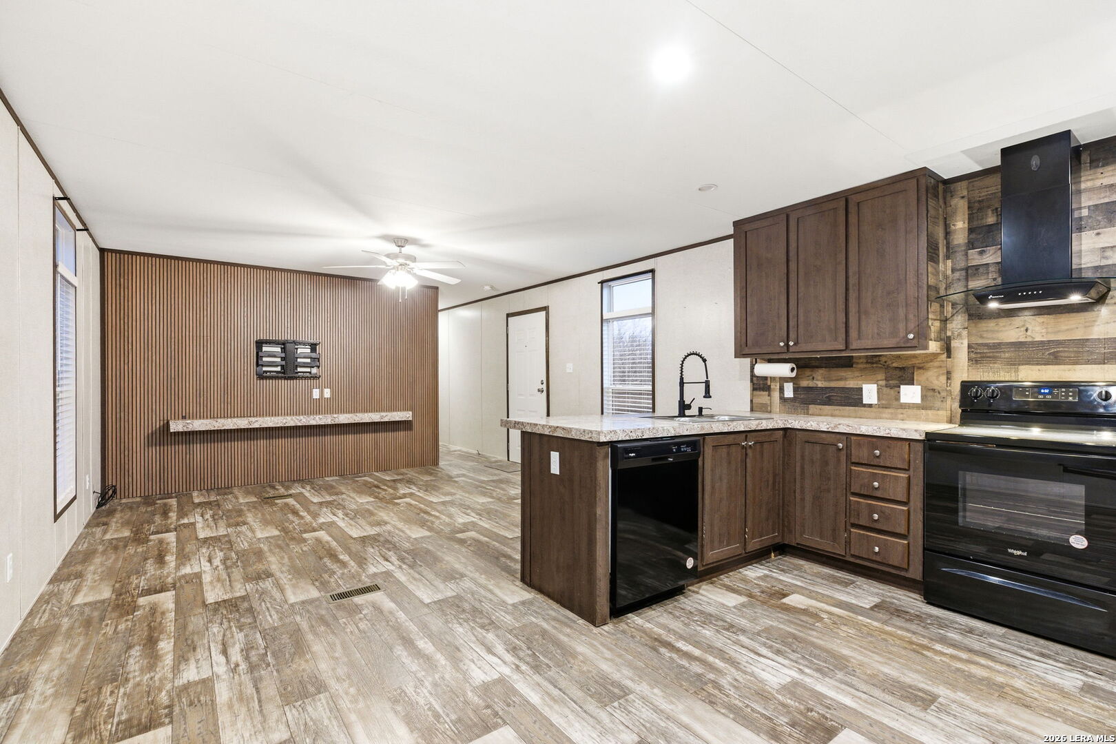 2383 Tomblin Road Bigfoot, TX 78005 - Photo 37 of 61 a kitchen with stainless steel appliances granite countertop a stove a sink and a microwave