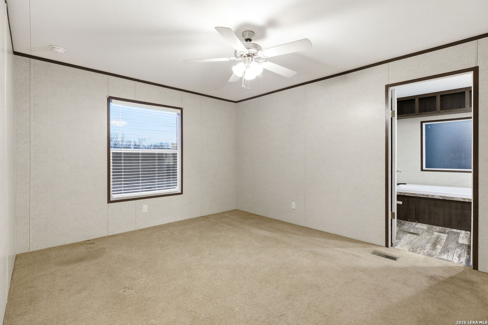 2383 Tomblin Road Bigfoot, TX 78005 - Photo 44 of 61 an empty room with windows and ceiling fan