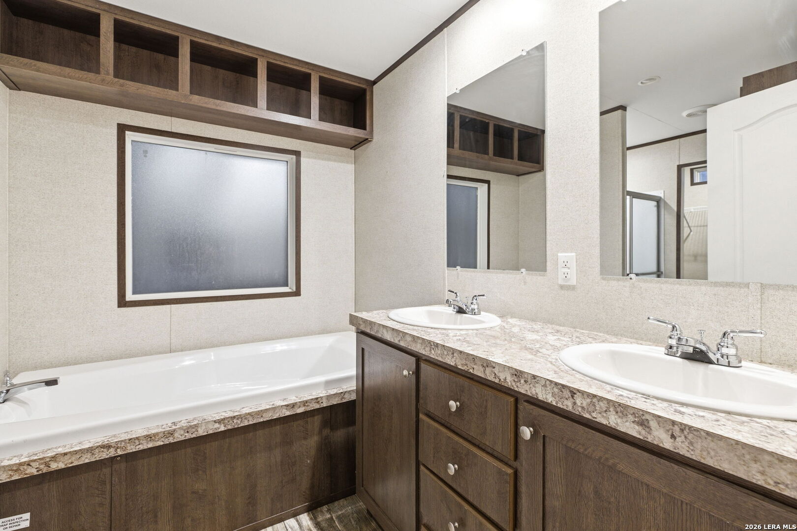 2383 Tomblin Road Bigfoot, TX 78005 - Photo 47 of 61 a bathroom with a granite countertop double vanity sink and mirror