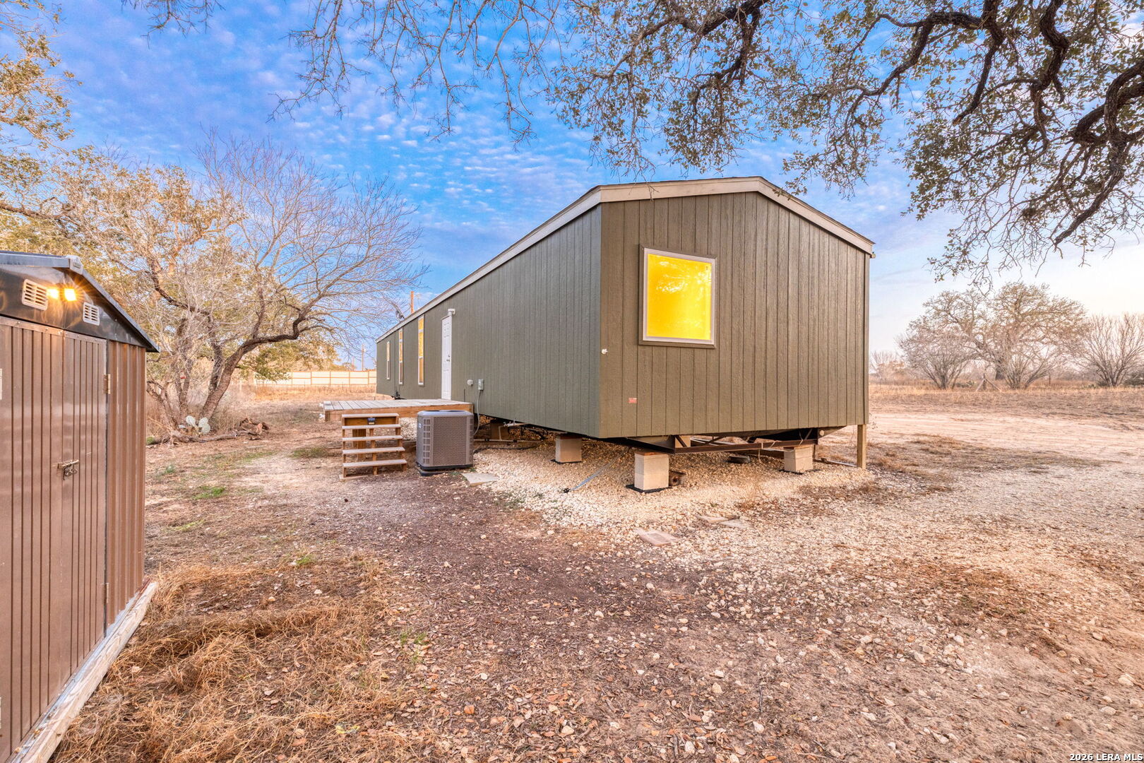 2383 Tomblin Road Bigfoot, TX 78005 - Photo 52 of 61 a view of backyard with wooden fence and large trees