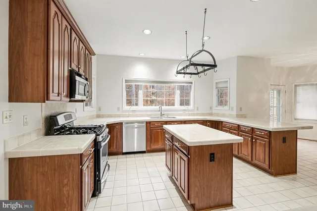 a kitchen that has a sink a stove and a microwave