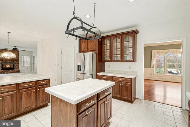 a kitchen with a stove a sink a refrigerator and wooden floor