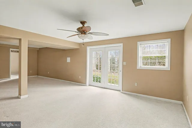 a view of a livingroom with a ceiling fan and window