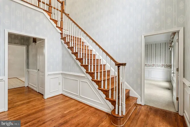 a view of entryway and hall with wooden floor