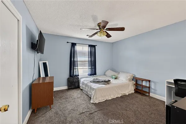 a bedroom with a bed and a flat tv screen