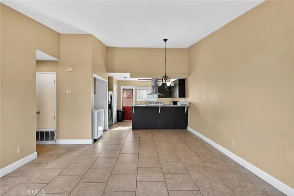 a large white kitchen with a sink a counter top space and stainless steel appliances