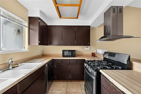 a kitchen with stainless steel appliances granite countertop a sink stove and microwave