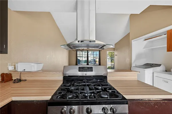 a kitchen with a stove and white cabinets