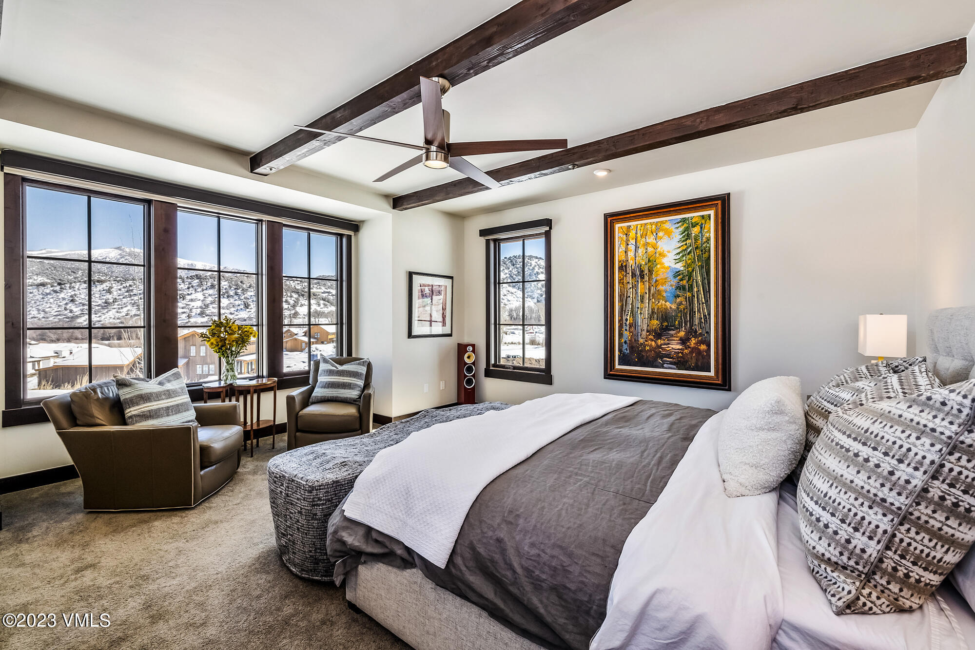 434 Hunters View Lane Eagle, CO 81631 - Photo 13 of 28 a spacious bedroom with a bed a couch and a window