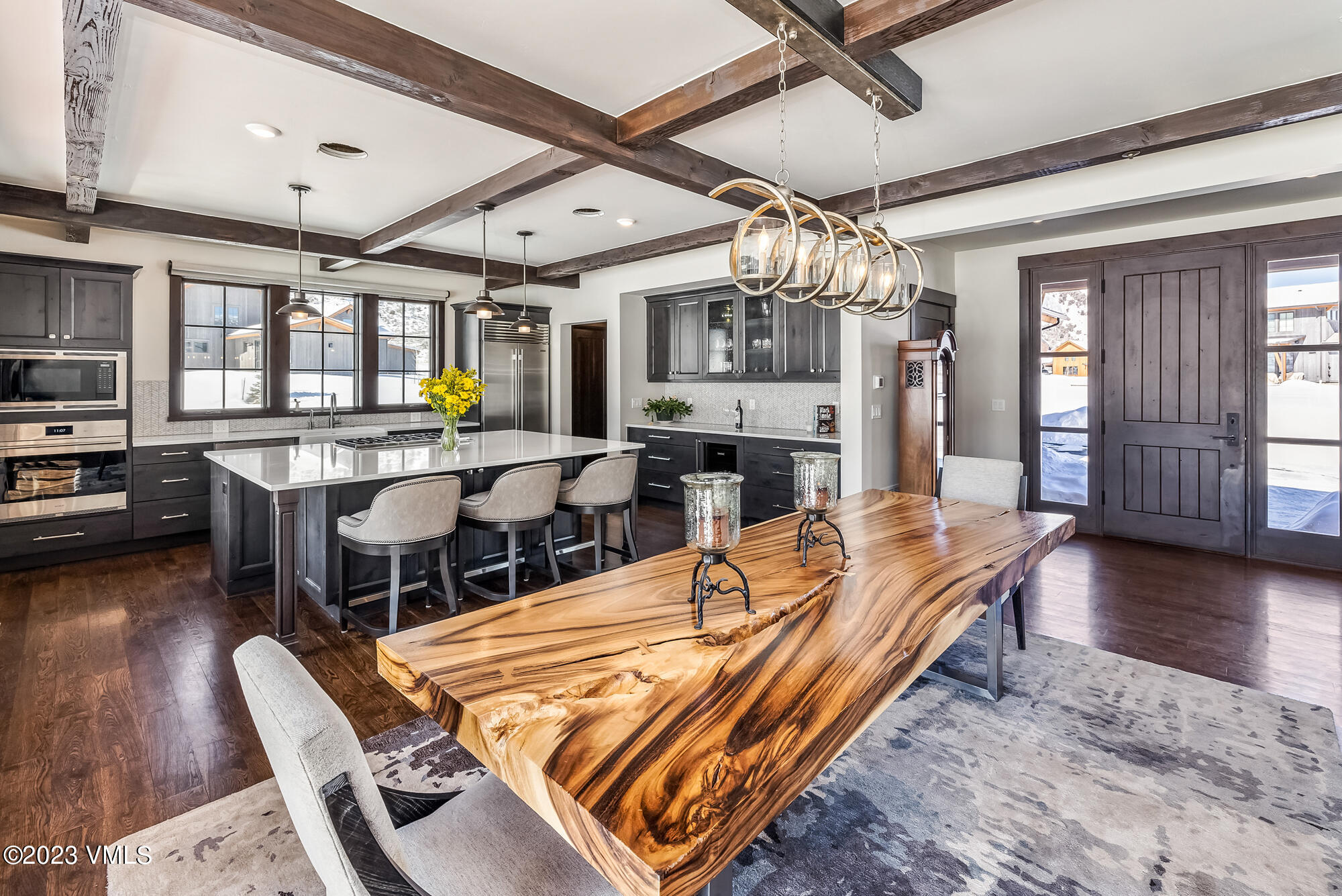 434 Hunters View Lane Eagle, CO 81631 - Photo 9 of 28 a dining room with wooden floor and chandelier