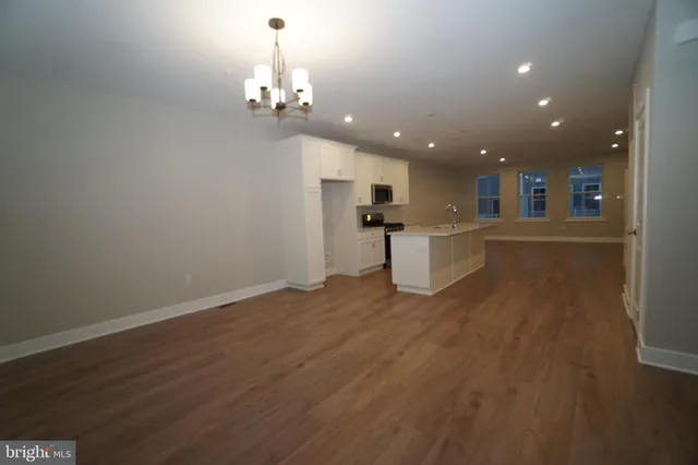 a view of a kitchen with a sink and dishwasher wooden floor