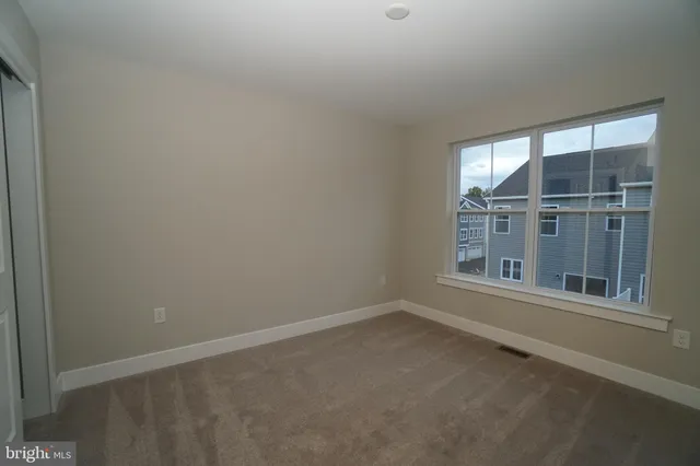 a bathroom with a granite countertop toilet and sink