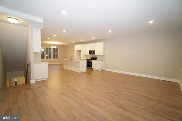 a view of a kitchen with a sink and a refrigerator