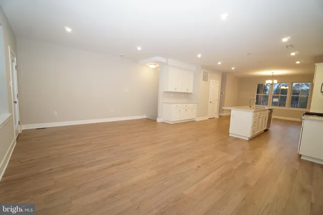 a view of a kitchen with a sink and wooden floor