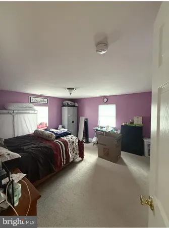 a spacious bedroom with a bed and furniture