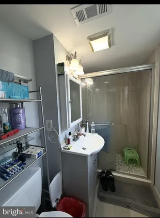 a bathroom with a sink toilet and shower