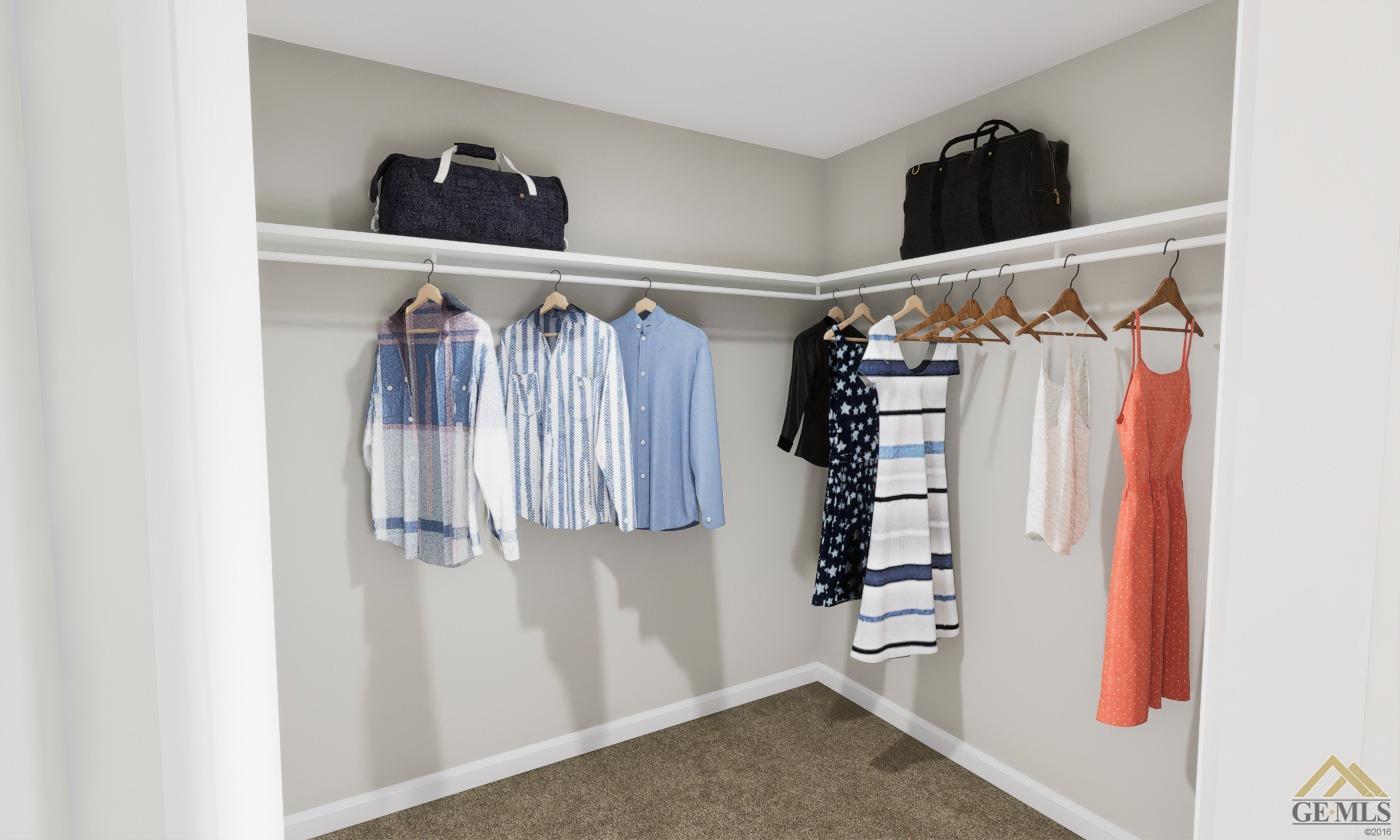 Undisclosed Address Bakersfield, CA 93313 - Photo 15 of 20 a view of walk in closet with clothes and shoes