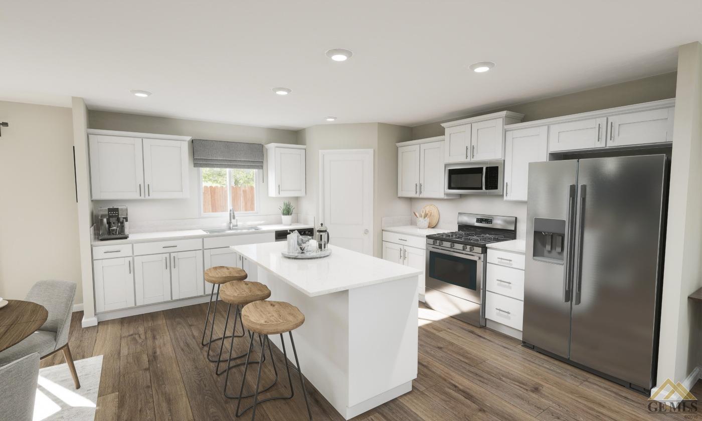 Undisclosed Address Bakersfield, CA 93313 - Photo 4 of 20 a kitchen with white cabinets and stainless steel appliances