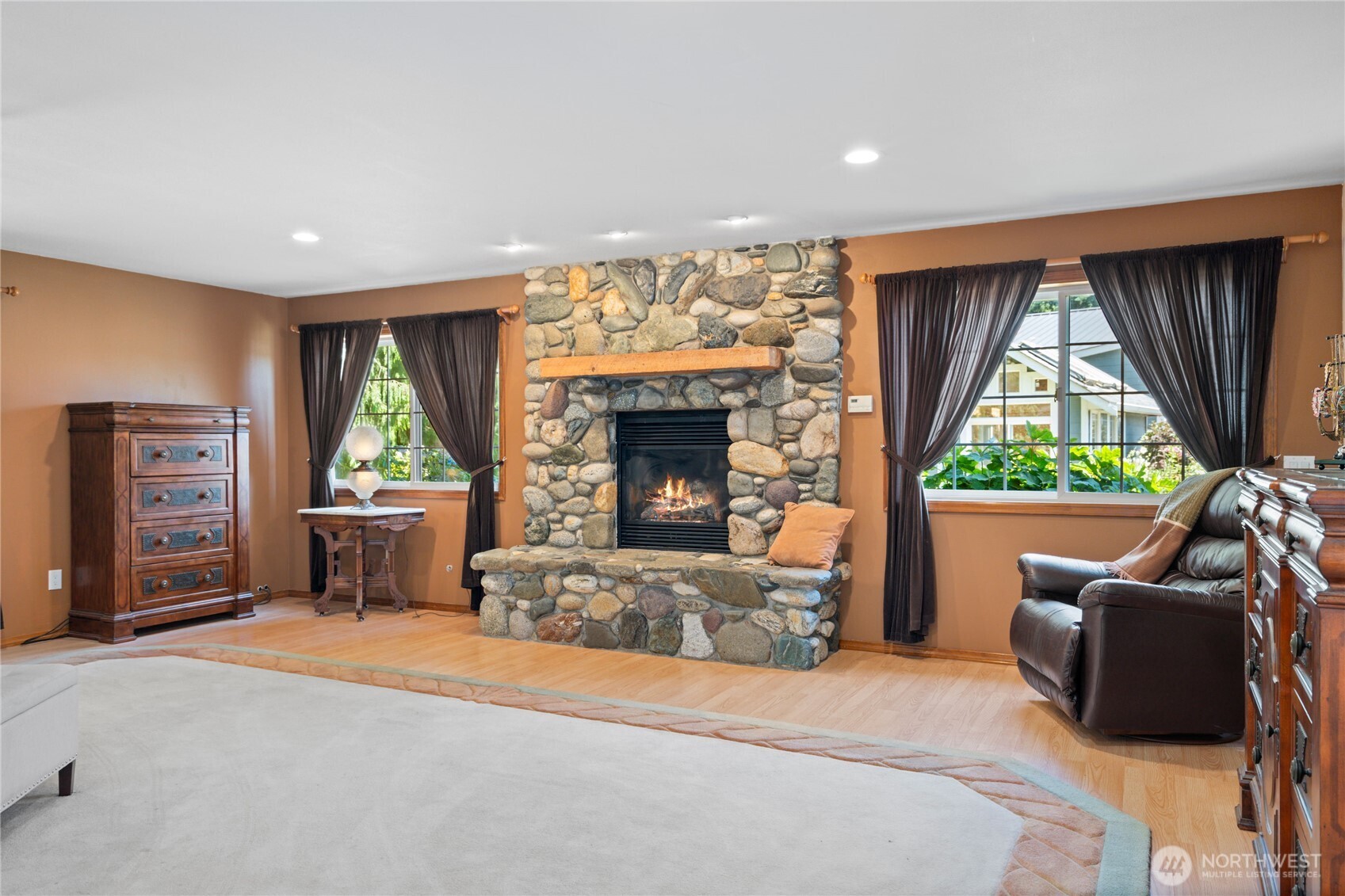3915 Silvana Terrace Road Stanwood, WA 98292 - Photo 22 of 40 a living room with furniture a fireplace and a flat screen tv