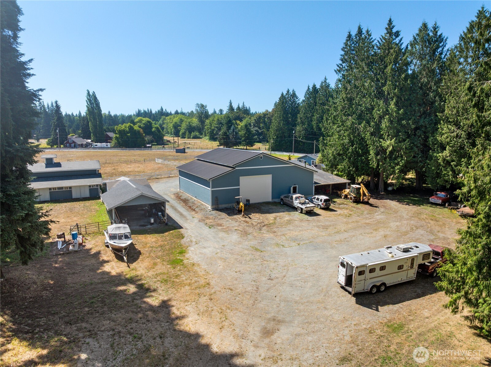 3915 Silvana Terrace Road Stanwood, WA 98292 - Photo 39 of 40 a view of a patio with a table and chairs under an umbrella