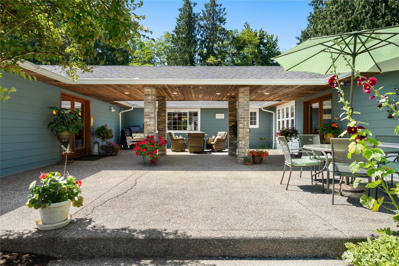 3915 Silvana Terrace Road Stanwood, WA 98292 - Photo 6 of 40 a view of a patio with table and chairs potted plants