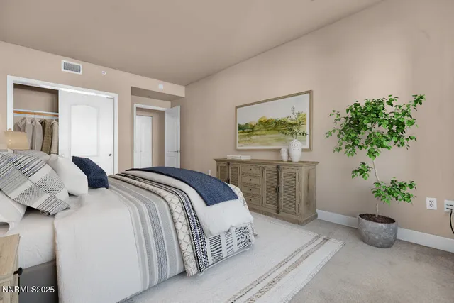 a bedroom with a bed and a potted plant