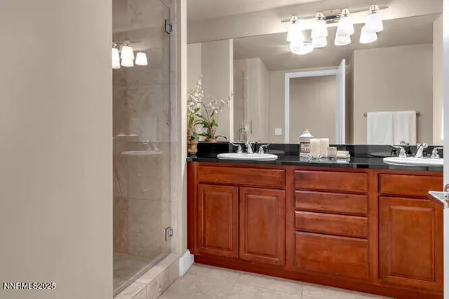 a bathroom with a sink a mirror and a shower