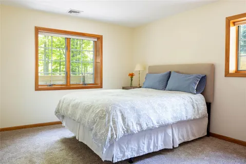 a bedroom with a bed and window