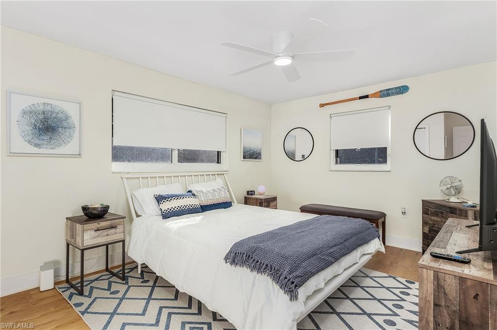 2950 Coach House Lane Naples, FL 34105 - Photo 12 of 50 a bedroom with a bed and a cabinets