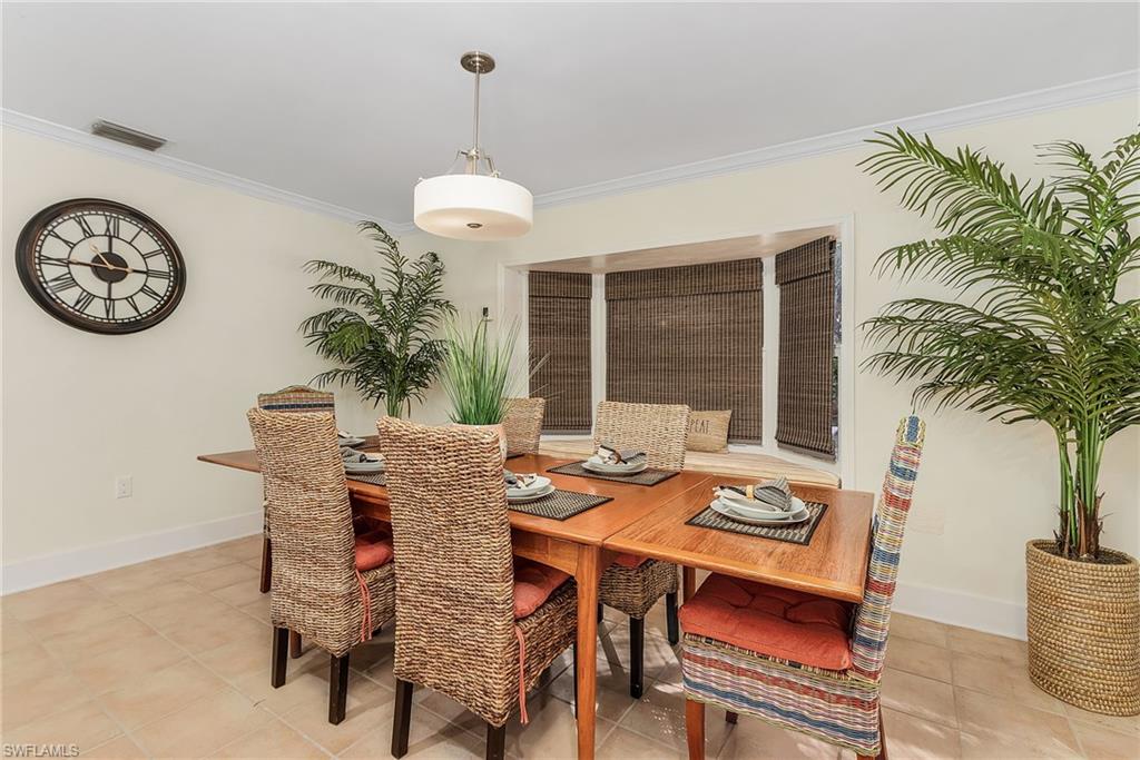 2950 Coach House Lane Naples, FL 34105 - Photo 15 of 50 a view of a dining room with furniture window and outside view
