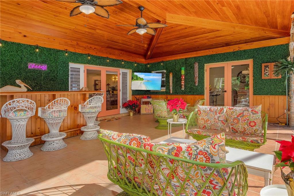 2950 Coach House Lane Naples, FL 34105 - Photo 30 of 50 a patio with swimming pool table and chairs