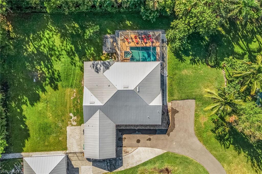 2950 Coach House Lane Naples, FL 34105 - Photo 32 of 50 an aerial view of a house with pool garden and outdoor seating