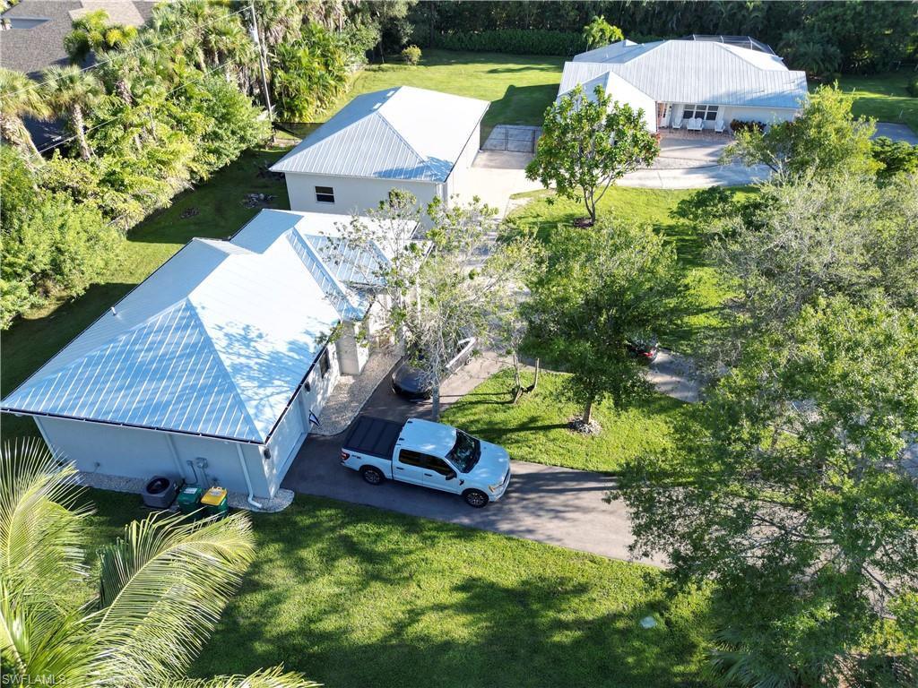 2950 Coach House Lane Naples, FL 34105 - Photo 40 of 50 a view of a house with a yard and sitting area