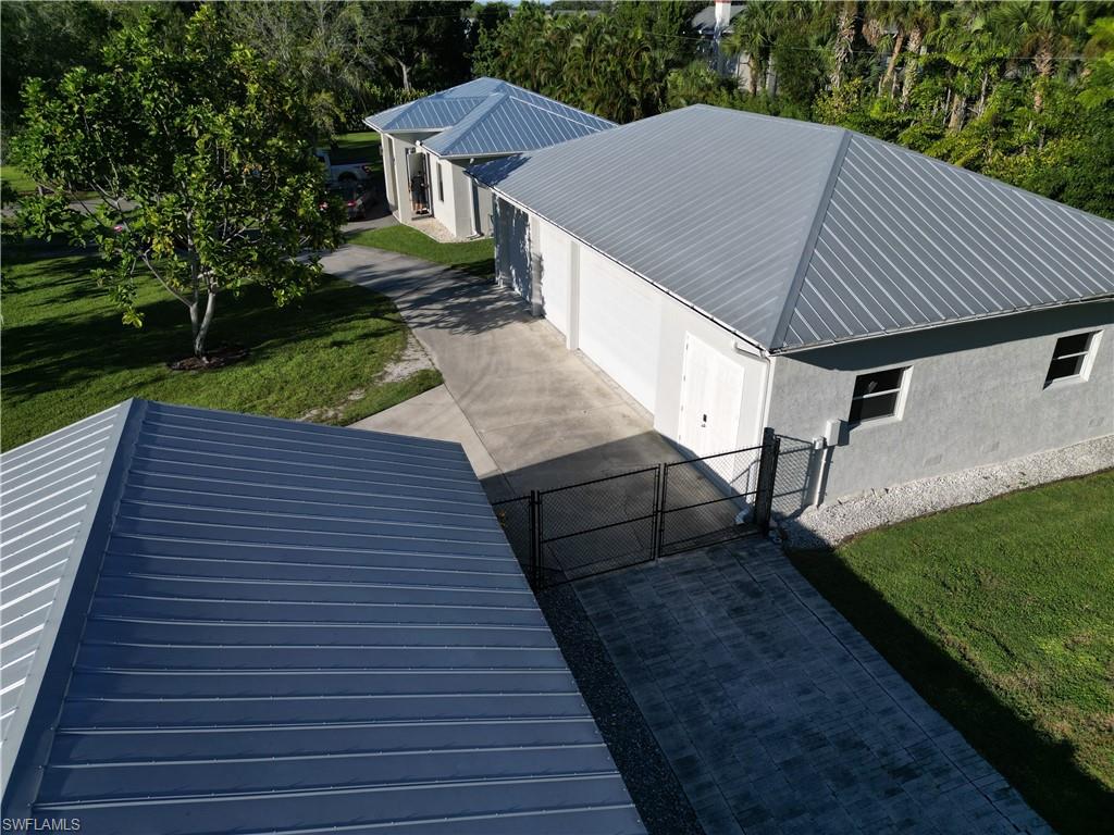 2950 Coach House Lane Naples, FL 34105 - Photo 41 of 50 a view of a backyard with sitting area