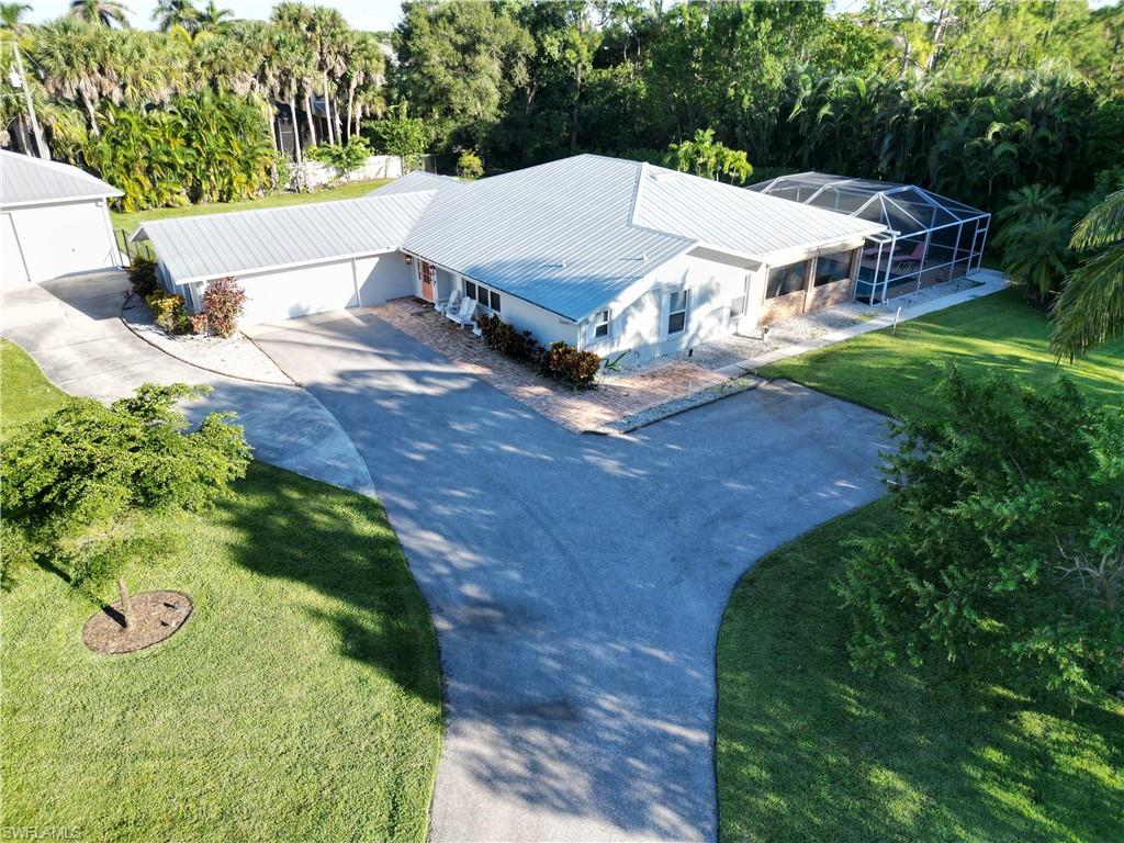 2950 Coach House Lane Naples, FL 34105 - Photo 42 of 50 an aerial view of a house with yard swimming pool and outdoor seating