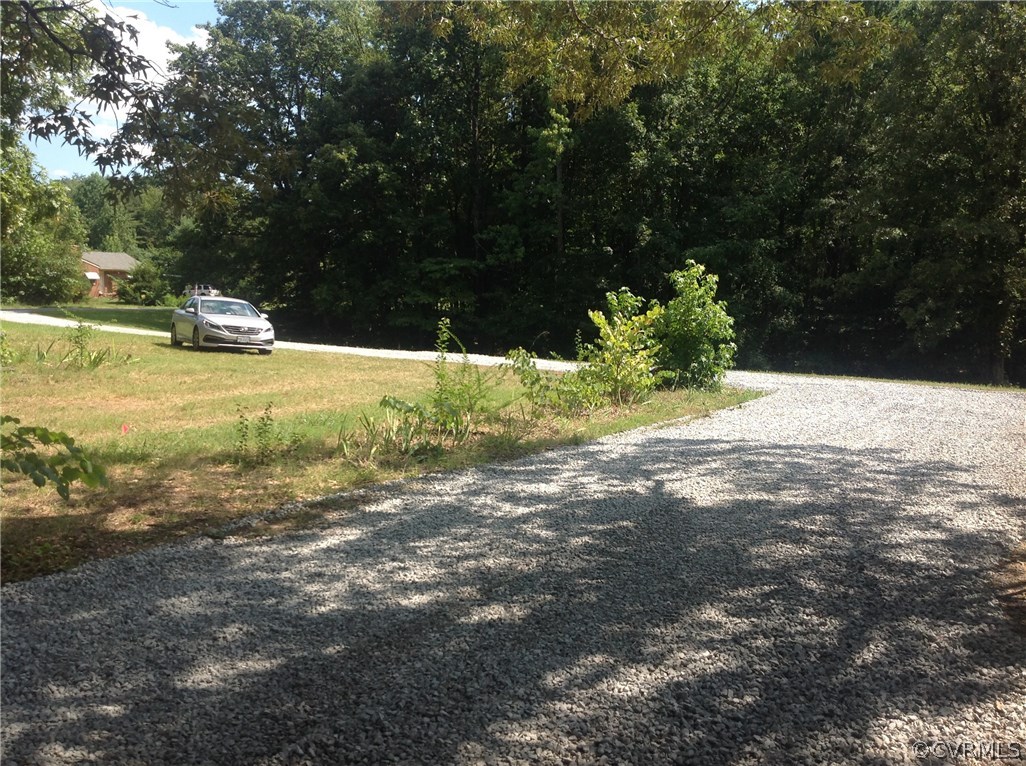 4563 New Line Road Gum Spring, VA 23065 - Photo 10 of 11 a view of a yard with yellow lighting
