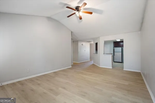 a view of a kitchen with a sink and a refrigerator