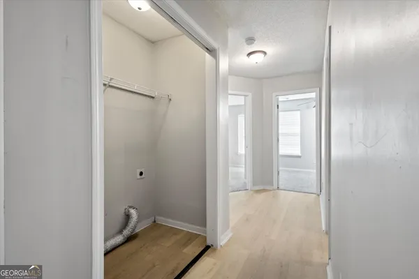 a view of a hallway with wooden floor