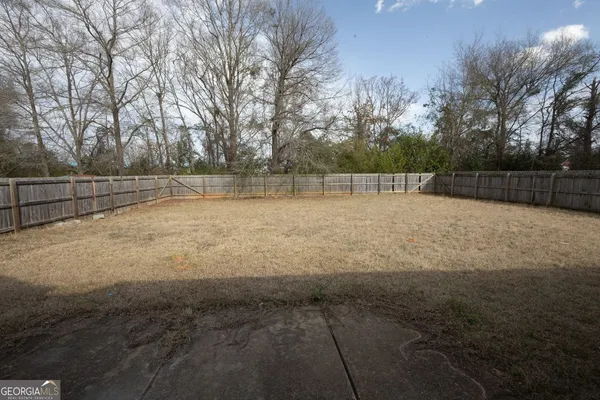 a view of a yard with large trees