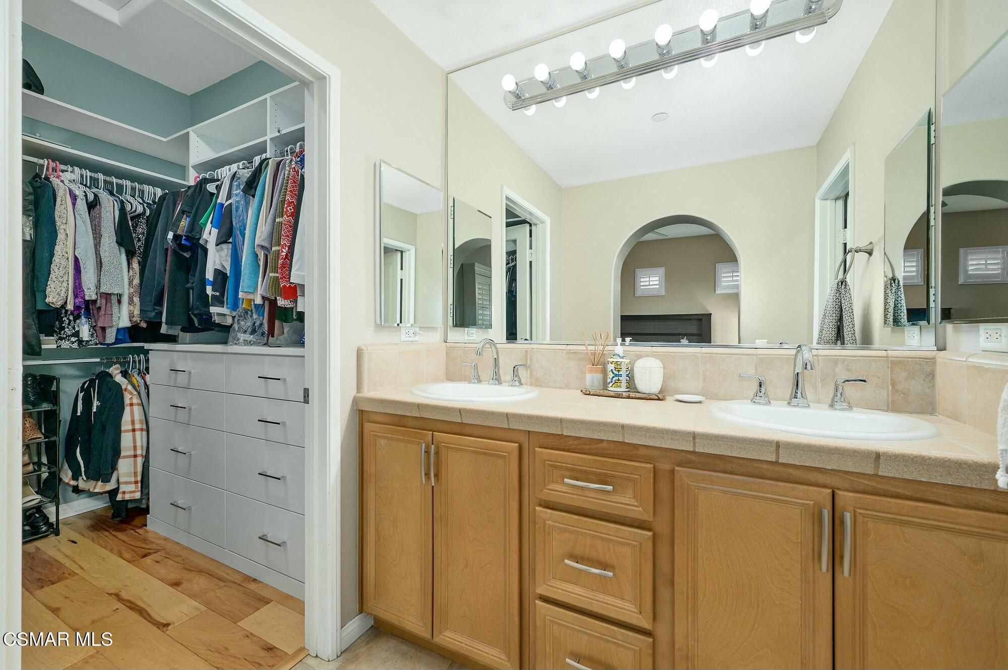 4121 Paredo Way, Unit D Simi Valley, CA 93063 - Photo 15 of 29 a bathroom with a double vanity sink and a mirror