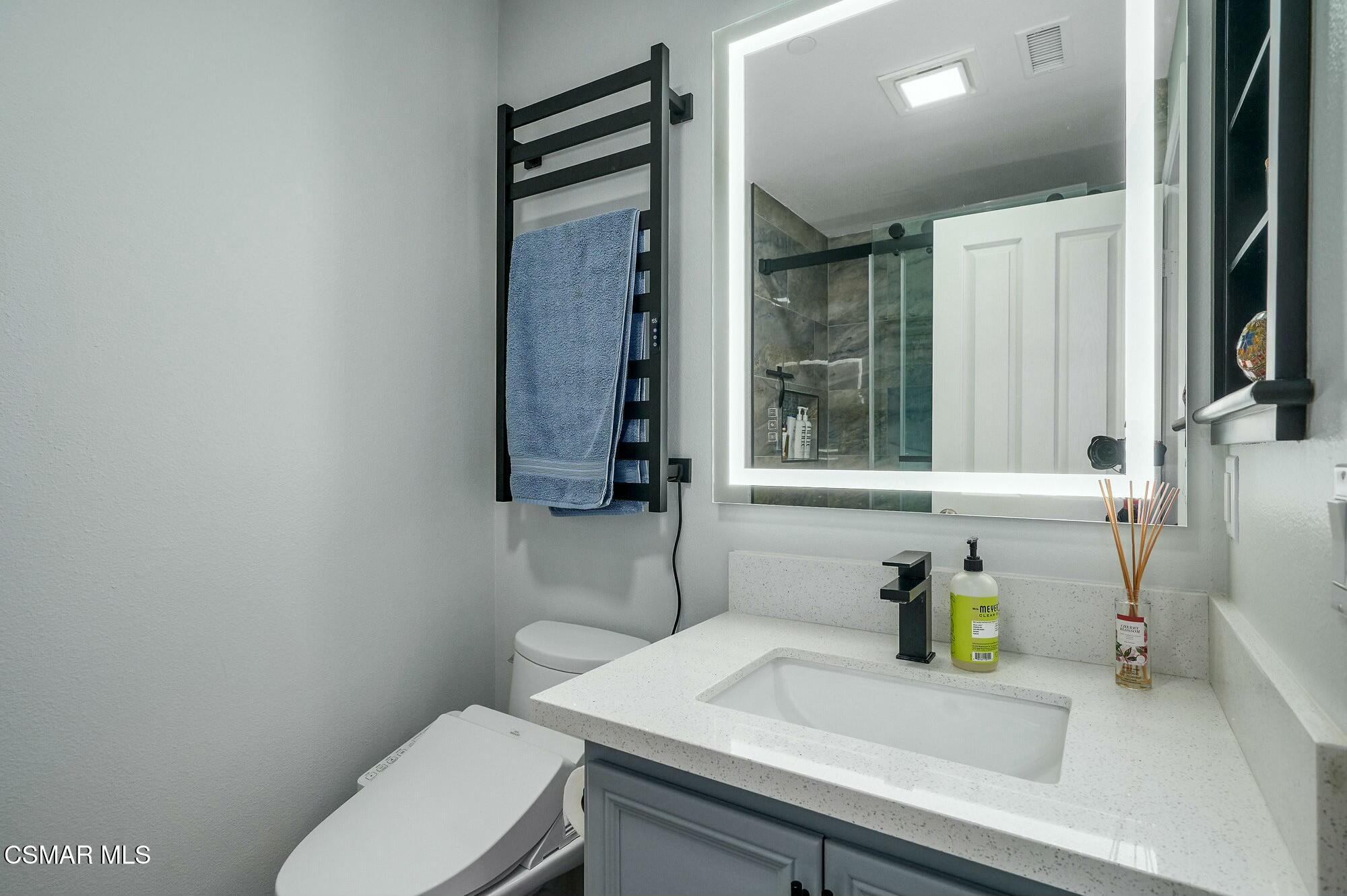 4121 Paredo Way, Unit D Simi Valley, CA 93063 - Photo 21 of 29 a bathroom with a sink a toilet and a mirror